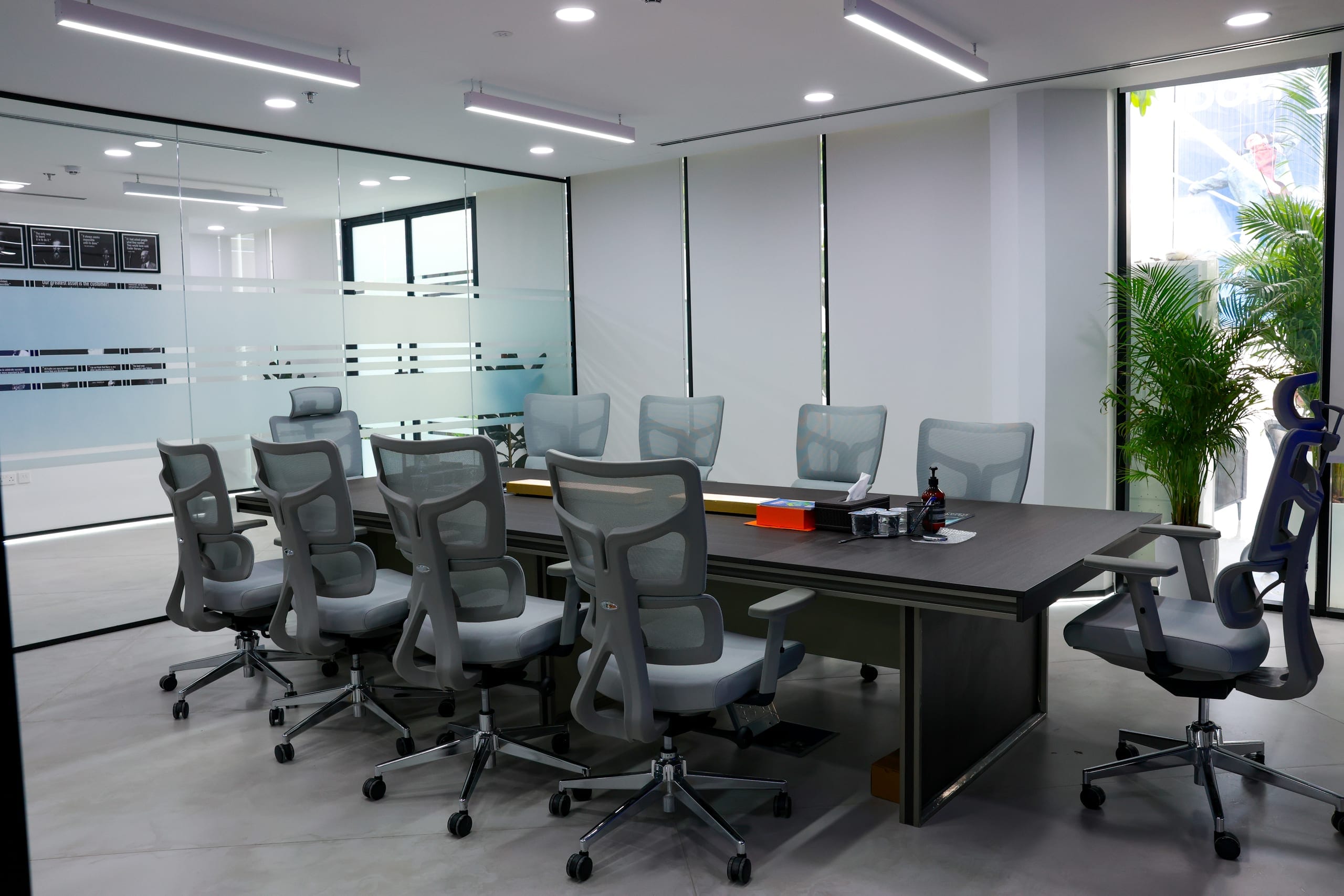 A completed boardroom, glazed to the office floor beyond